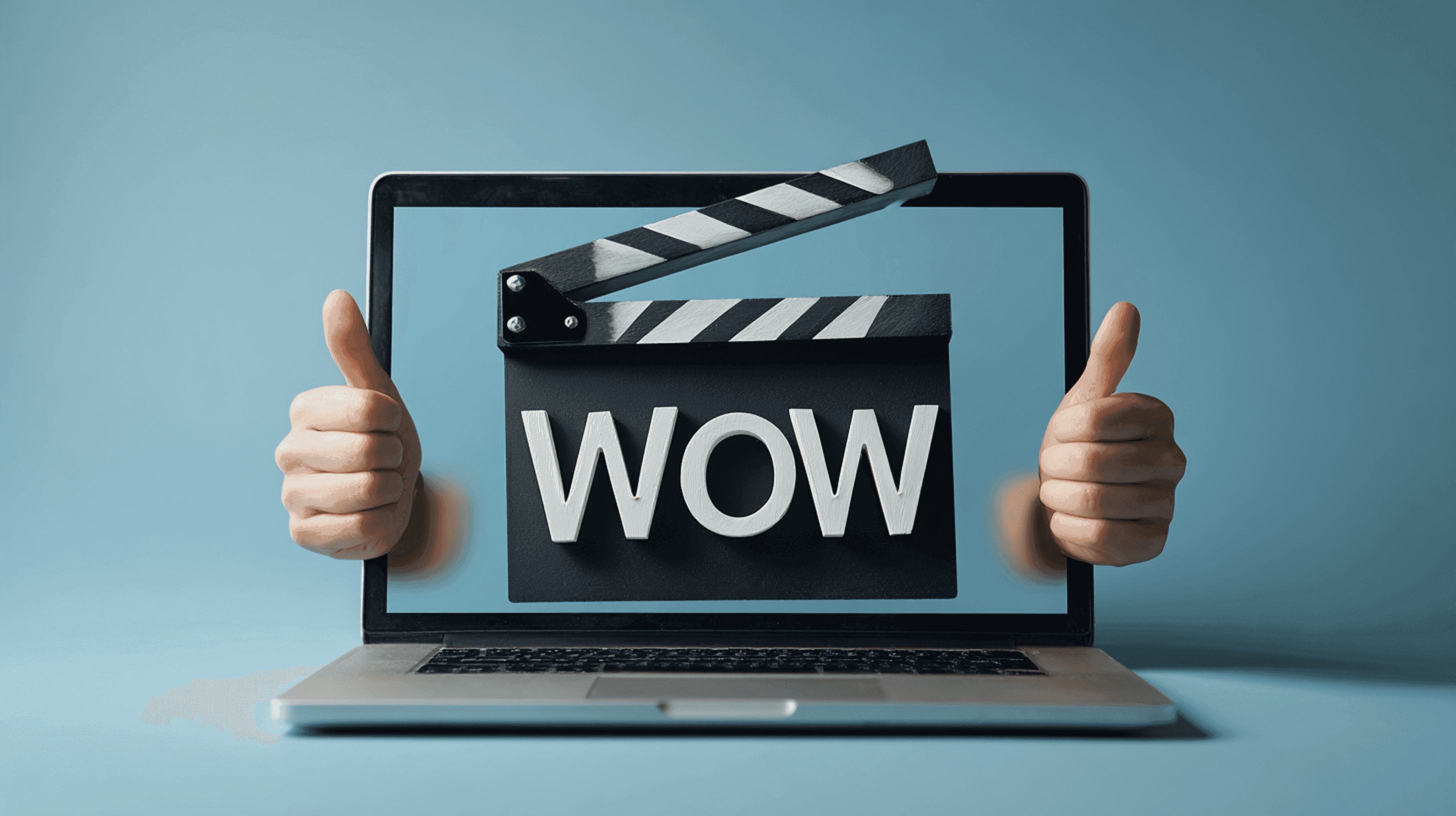A laptop screen with a 3D clapperboard and double thumbs up flanking the sides of the screen.